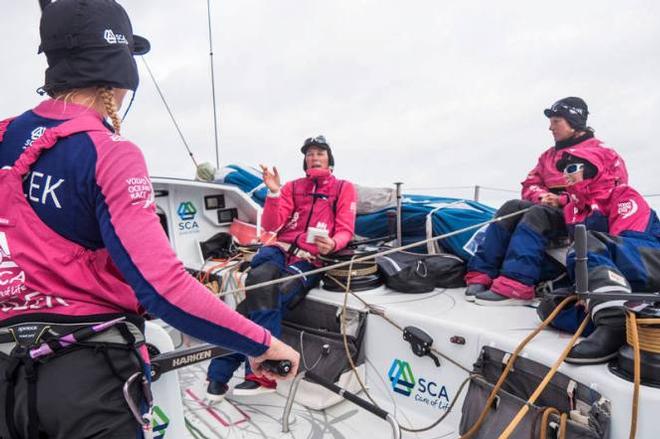 Onboard Team SCA - Carolijn Brouwer is giving the 1900 UTC position. Good news compared to the one at 1400. Abby Ehler,Sara Hastreiter and Sophie Ciszek on watch - Leg 7 to Lisbon - Volvo Ocean Race © Anna-Lena Elled/Team SCA